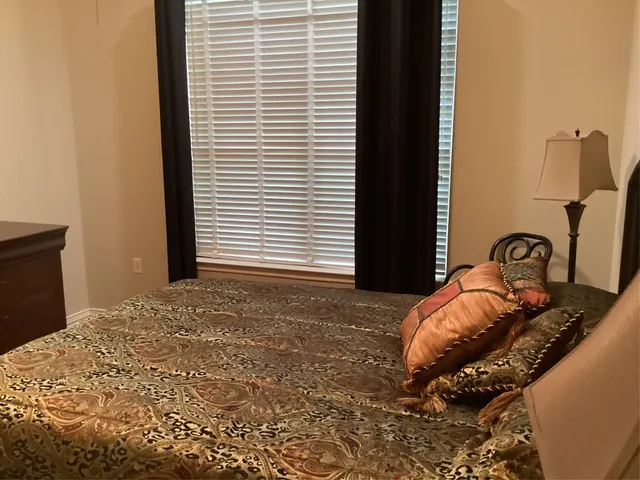 a bedroom with a bed and a window