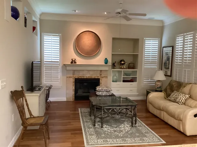 a living room with furniture a window and a fireplace