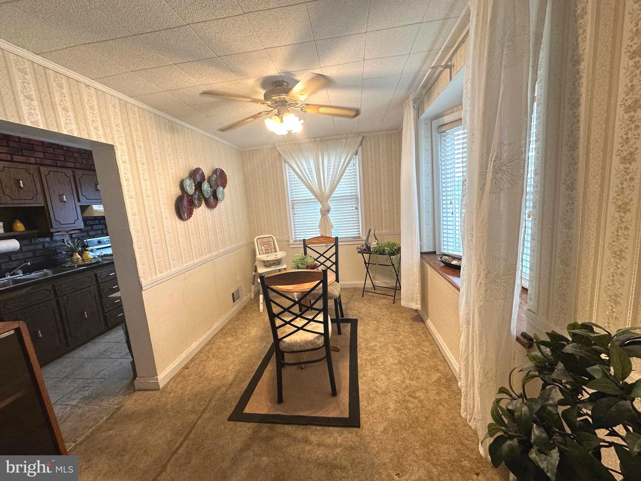 8454 Kavanagh Road Baltimore, MD 21222 - Photo 11 of 23 a view of a dining room with furniture and a chandelier