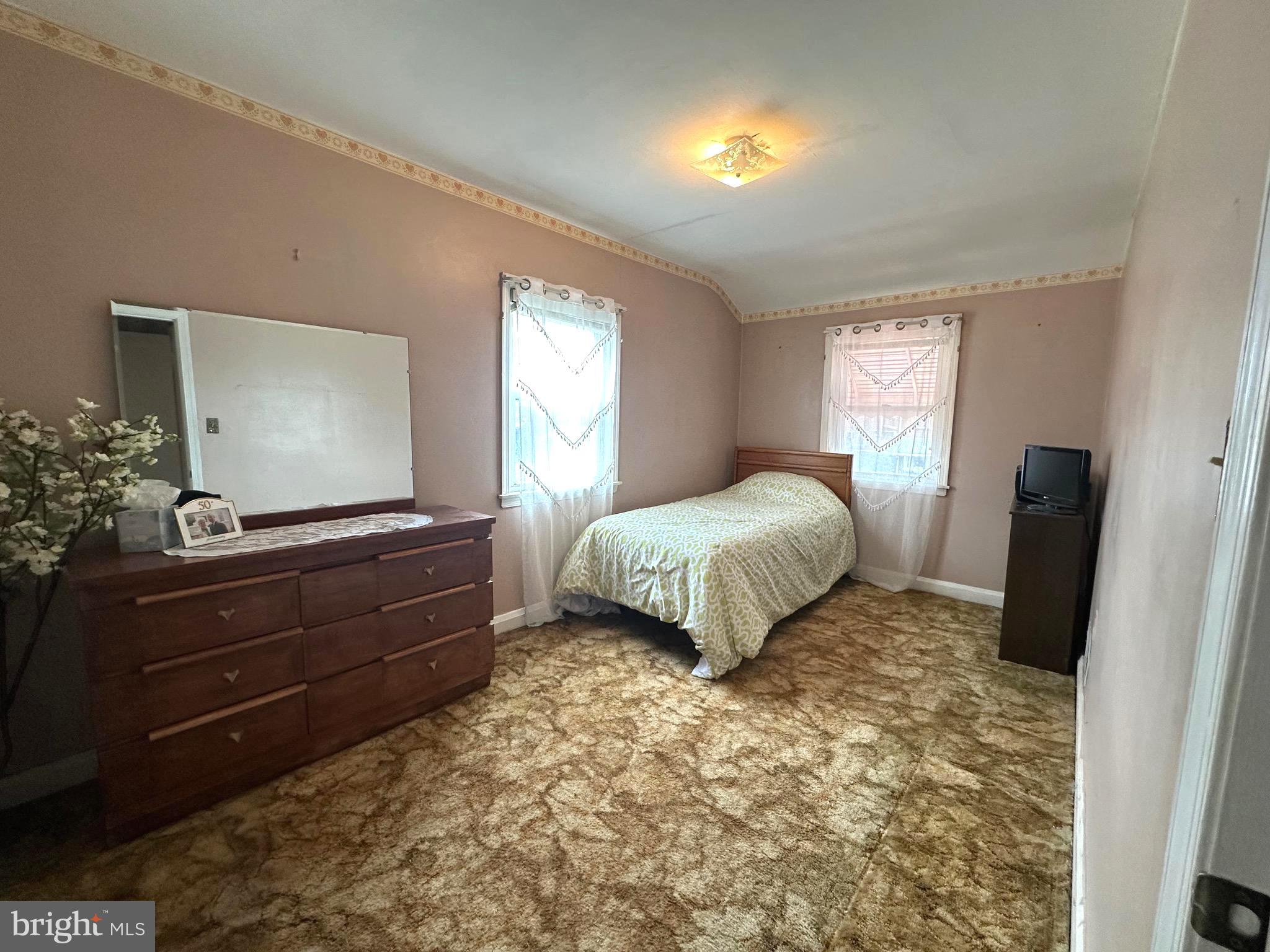 8454 Kavanagh Road Baltimore, MD 21222 - Photo 17 of 23 a bedroom with a bed window and mirror