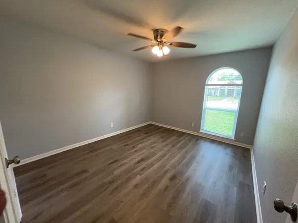a view of wooden floor chandelier and window in a room