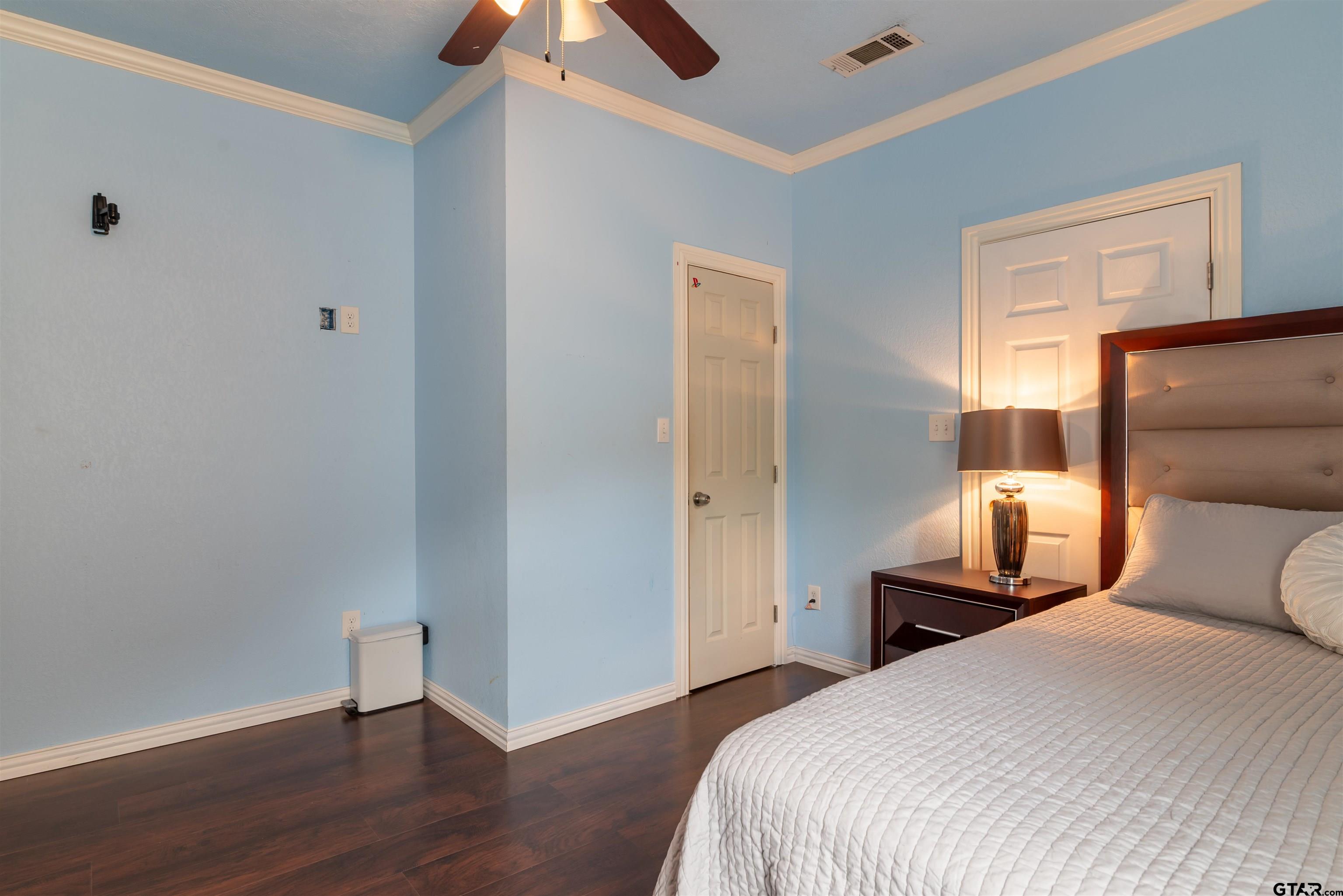 427 East Locust Street Tyler, TX 75702 - Photo 24 of 42 a bedroom with a bed and a lamp