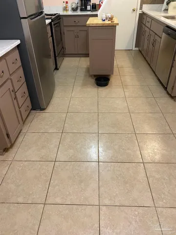 a kitchen with stainless steel appliances a refrigerator stove and microwave