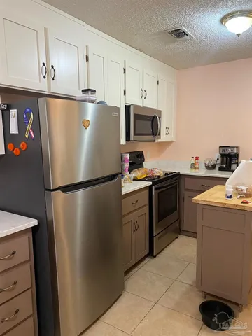 a white refrigerator freezer sitting in a kitchen