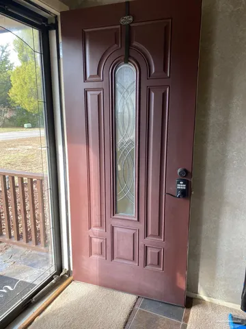 a view of a hallway with wooden floor and windows