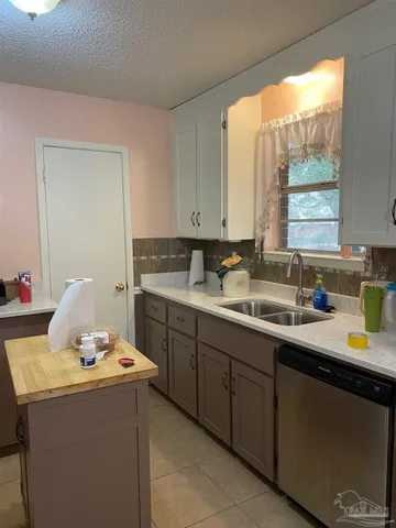 a stove top oven sitting inside of a kitchen