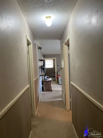 a view of hallway with livingroom and furniture