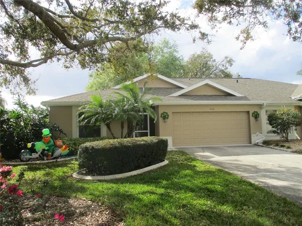 a view of a house with a yard and a garden