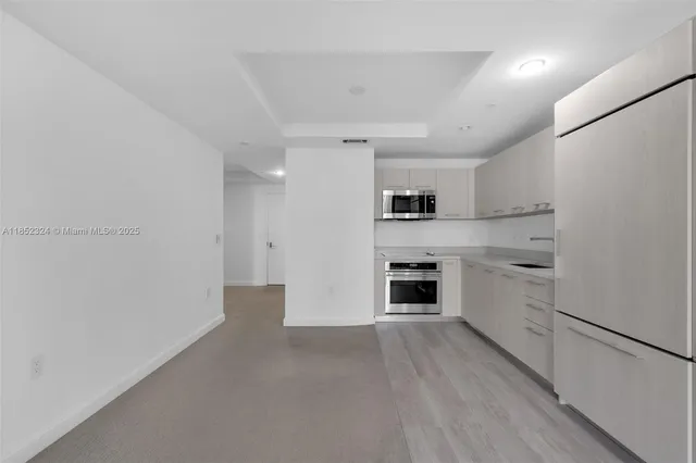 a kitchen with white cabinets and white appliances