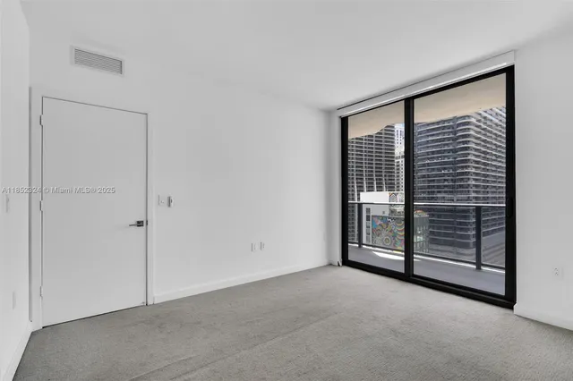 a view of an empty room with a fireplace