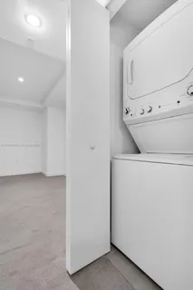 a bathroom with a shower sink mirror and toilet