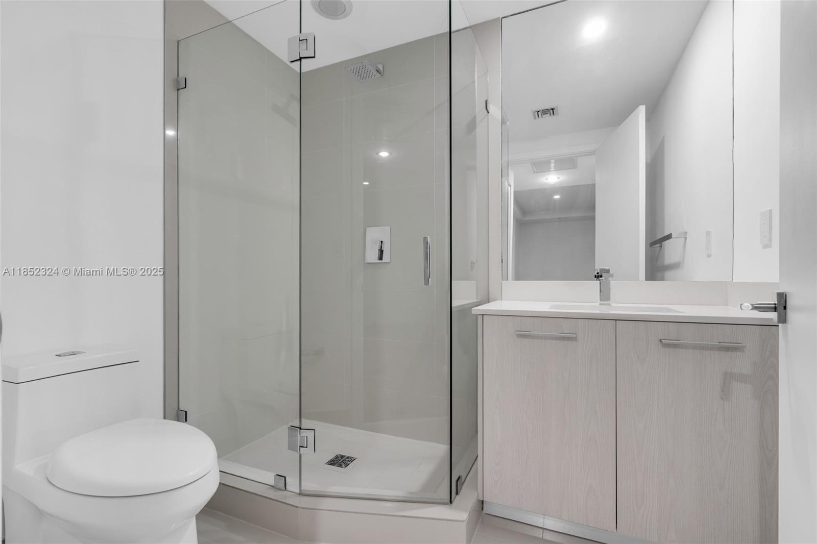 45 Southwest 9th Street, Unit 2204 Miami, FL 33130 - Photo 25 of 39 a bathroom with a shower sink mirror and toilet