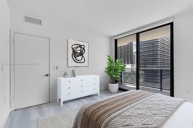 a bedroom with a bed and a large mirror