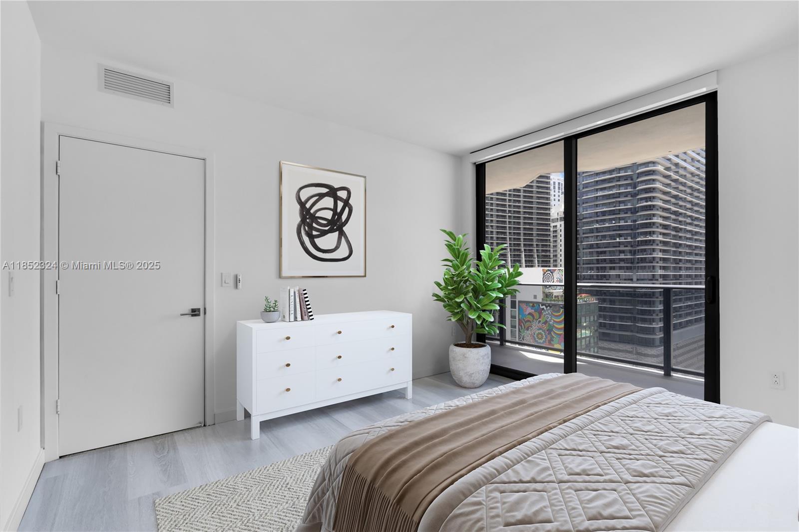 45 Southwest 9th Street, Unit 2204 Miami, FL 33130 - Photo 3 of 39 a bedroom with a bed and a large mirror