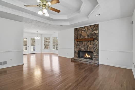 1828 4 Mile Church Road Ball Ground, GA 30107 - Photo 11 of 46 a view of an empty room with wooden floor fireplace and a window
