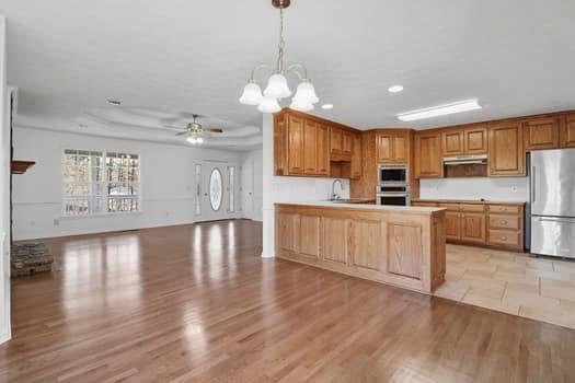 1828 4 Mile Church Road Ball Ground, GA 30107 - Photo 17 of 46 a open kitchen with cabinets a refrigerator and a stove top oven