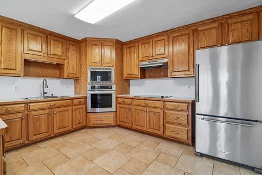 1828 4 Mile Church Road Ball Ground, GA 30107 - Photo 20 of 46 a kitchen with stainless steel appliances granite countertop a refrigerator sink and cabinets