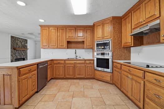 1828 4 Mile Church Road Ball Ground, GA 30107 - Photo 21 of 46 a kitchen with stainless steel appliances granite countertop a stove and a sink