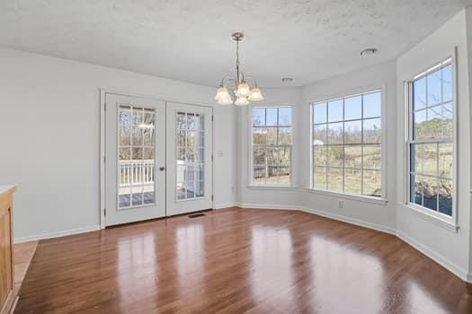 1828 4 Mile Church Road Ball Ground, GA 30107 - Photo 22 of 46 a view of an empty room with wooden floor and a window