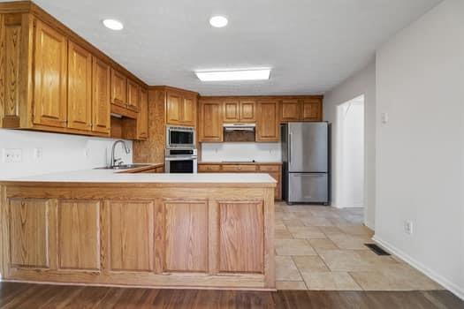 1828 4 Mile Church Road Ball Ground, GA 30107 - Photo 24 of 46 a kitchen with stainless steel appliances a refrigerator and cabinets
