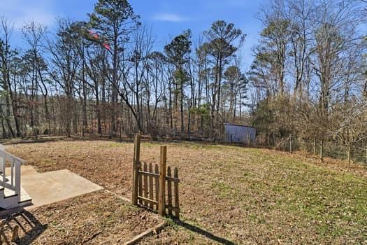 1828 4 Mile Church Road Ball Ground, GA 30107 - Photo 25 of 46 a backyard of a house with lots of green space