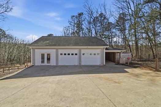 1828 4 Mile Church Road Ball Ground, GA 30107 - Photo 26 of 46 a front view of a house with a yard and garage