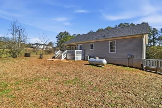 1828 4 Mile Church Road Ball Ground, GA 30107 - Photo 8 of 46 a backyard of a house with table and chairs