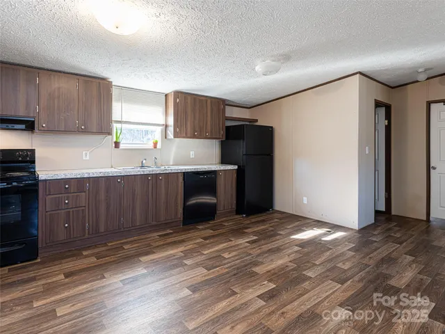 a kitchen with stainless steel appliances a refrigerator and a sink