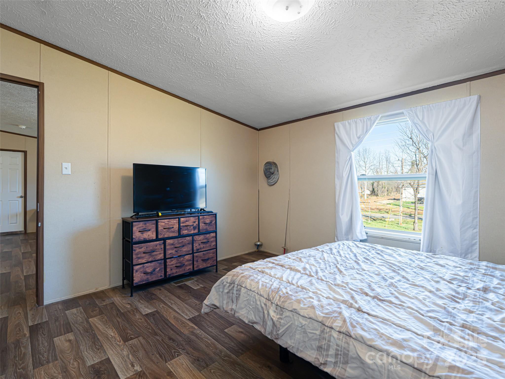 4148 Tallent Road Morganton, NC 28655 - Photo 17 of 30 a bedroom with a bed and flat screen tv