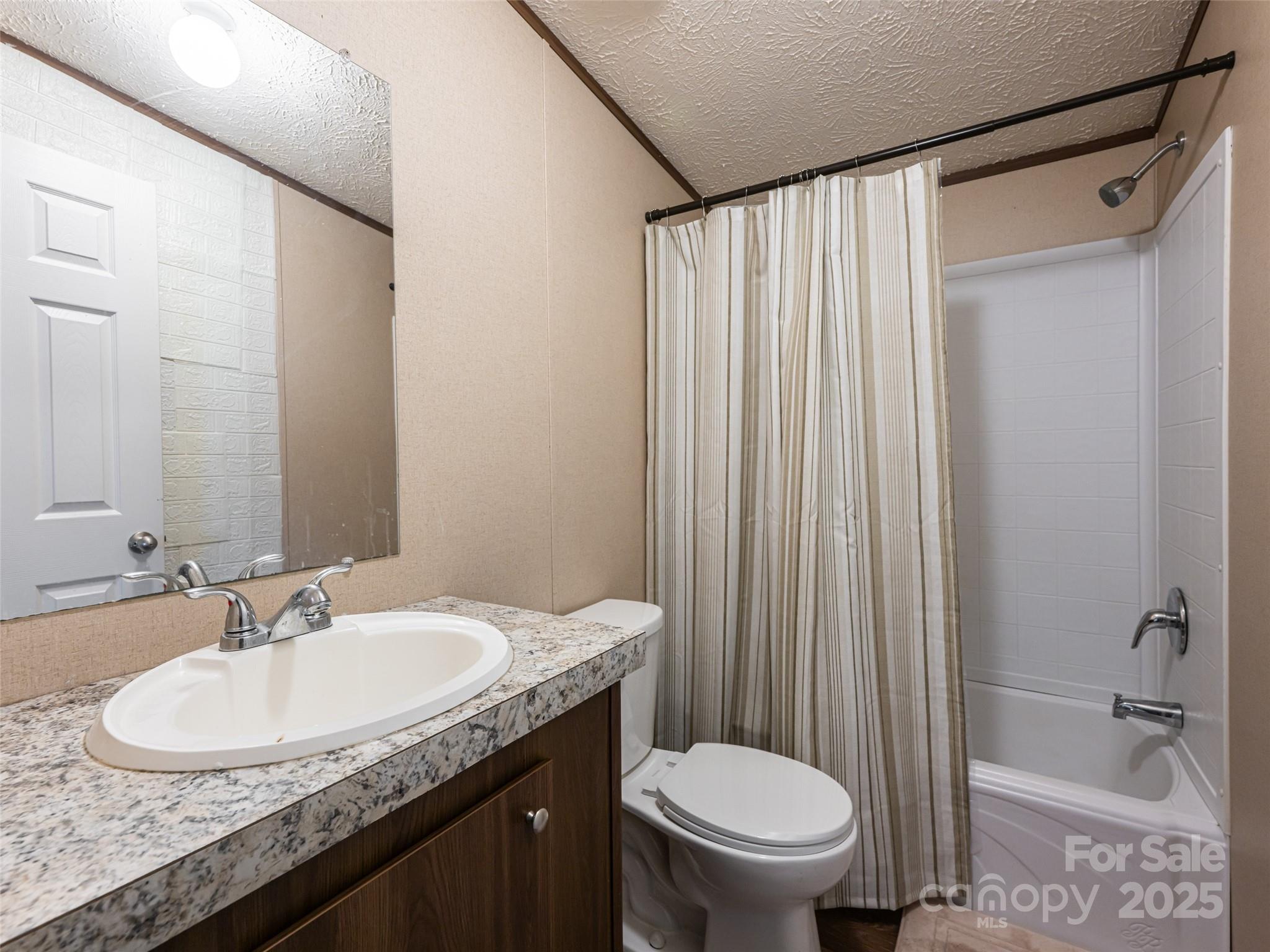 4148 Tallent Road Morganton, NC 28655 - Photo 20 of 30 a bathroom with a granite countertop sink toilet and shower