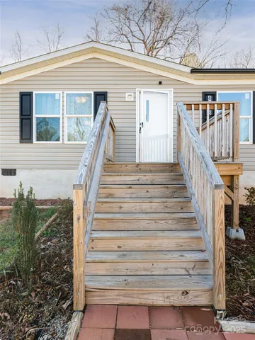 a view of entryway with wooden floor and a front door