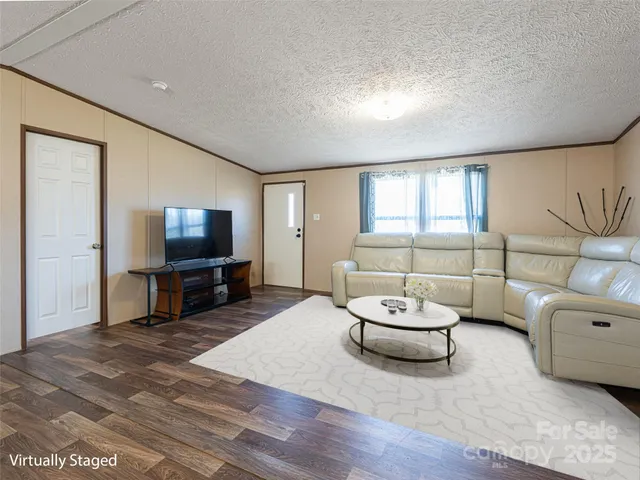 a living room with furniture a window and a flat screen tv