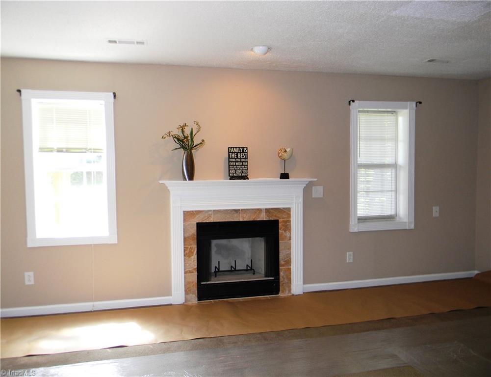 4680 Hampton Road Clemmons, NC 27012 - Photo 22 of 27 Large Lower Level Playroom with Pretty Fireplace