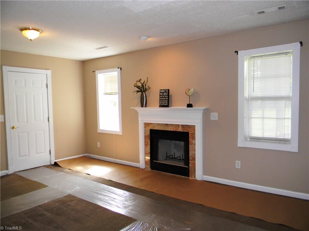 4680 Hampton Road Clemmons, NC 27012 - Photo 24 of 27 Abundant Light in Playroom. Directional Lighting over Mantel. Playroom has additional storage under stairwell.