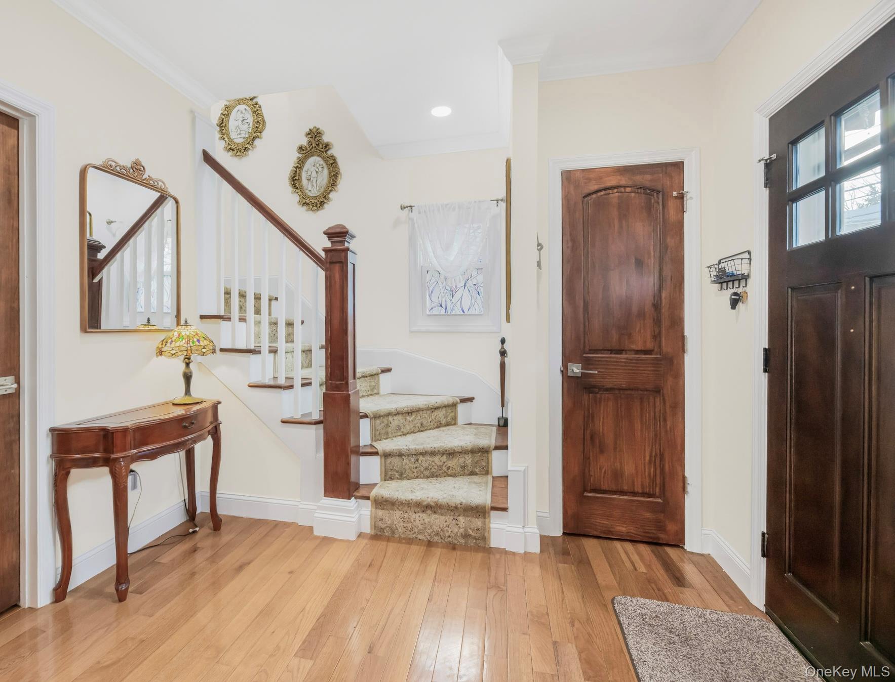 248 Rockne Road Yonkers, NY 10701 - Photo 19 of 40 Foyer entrance featuring stairs, light wood-type flooring, and crown molding