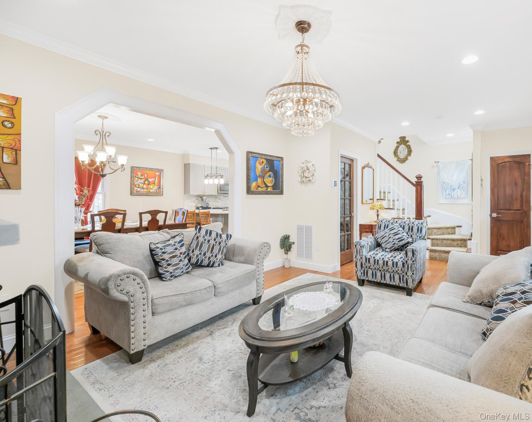 248 Rockne Road Yonkers, NY 10701 - Photo 22 of 40 Living room featuring a chandelier, stairway, wood finished floors, recessed lighting, and ornamental molding