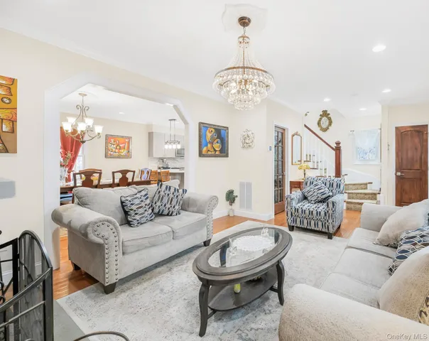 a living room with furniture a chandelier and a chandelier