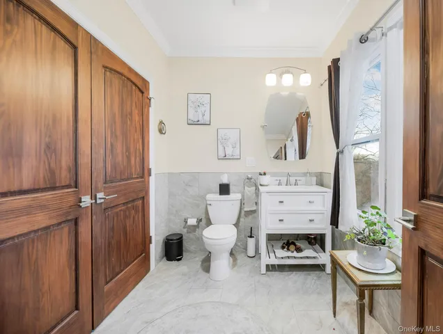 a bathroom with a toilet a sink and a mirror