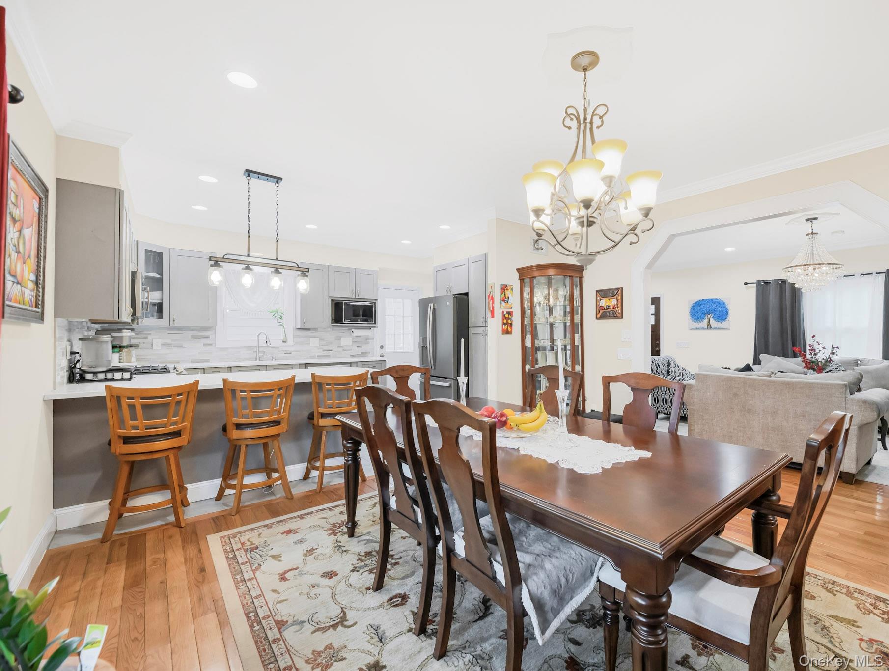248 Rockne Road Yonkers, NY 10701 - Photo 27 of 40 Dining area featuring ornamental molding, light wood-style flooring, recessed lighting, and a chandelier