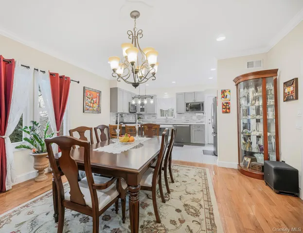 a view of a dining room with furniture and chandelier