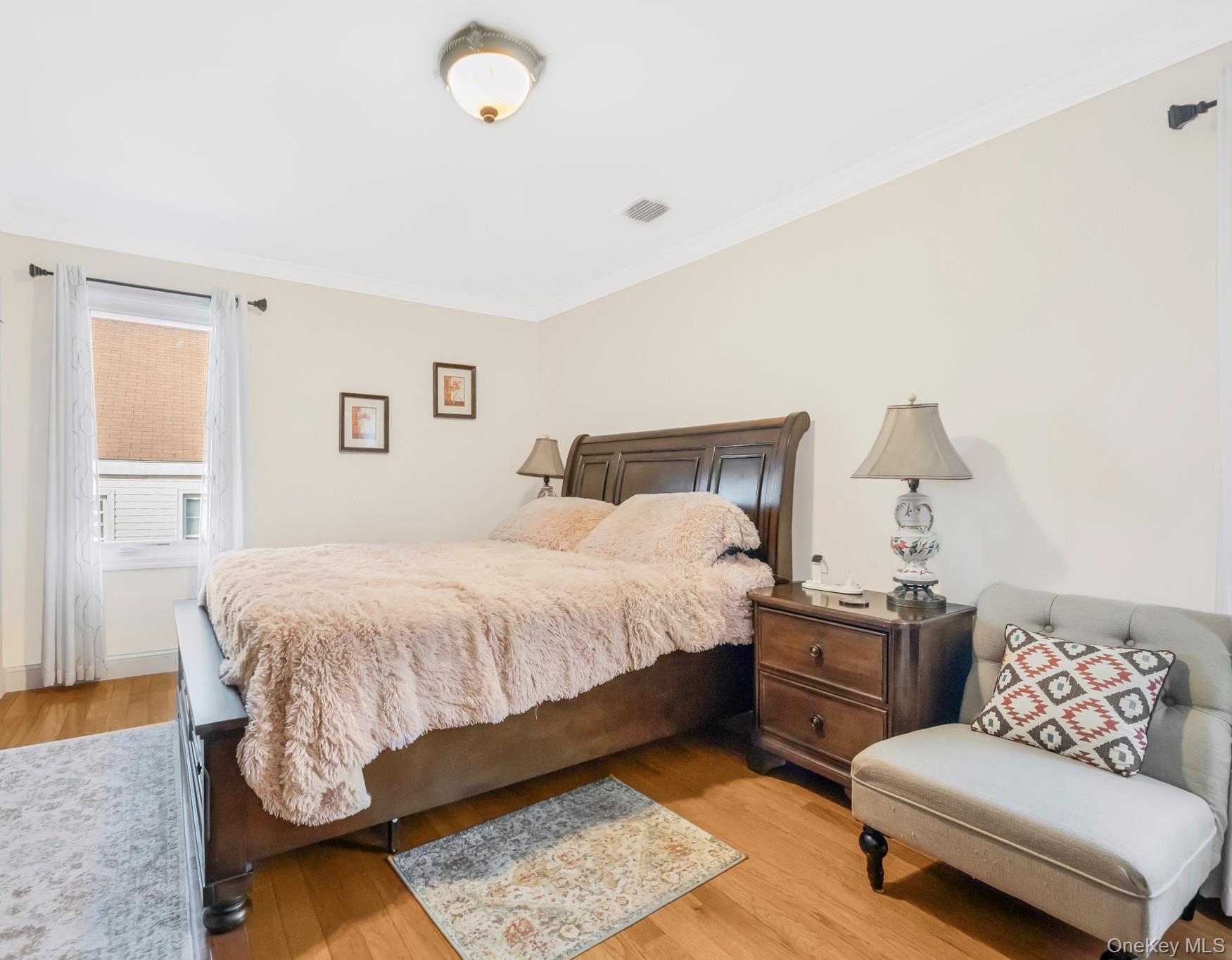 248 Rockne Road Yonkers, NY 10701 - Photo 33 of 40 Bedroom featuring light wood finished floors and crown molding
