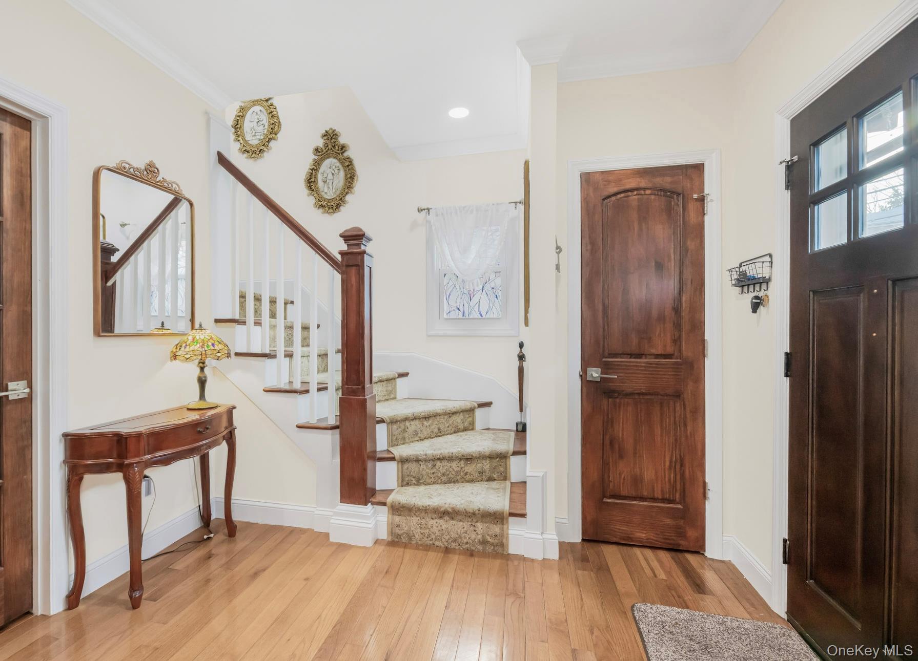 248 Rockne Road Yonkers, NY 10701 - Photo 38 of 40 Entryway featuring stairs, light wood-style floors, and crown molding