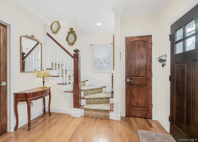 a view of entryway and hall with wooden floor