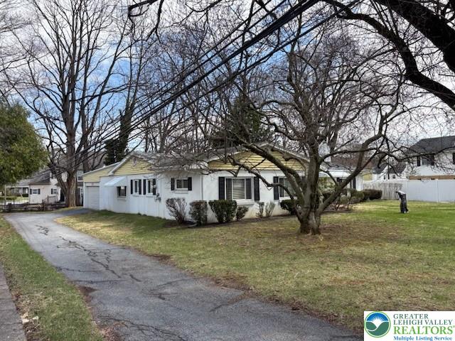 627 North Main Street Allentown, PA 18104 - Photo 3 of 24 a front view of a house with a yard covered with trees