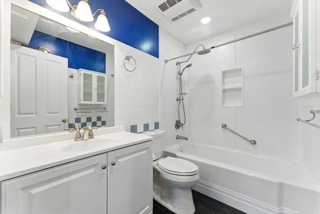 a bathroom with a toilet a sink and a mirror