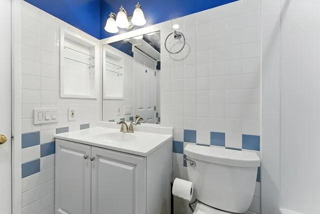 a view of a hallway with wooden shelves