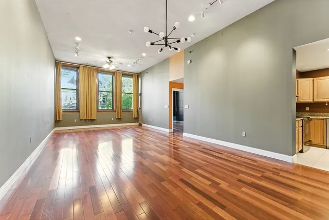 a view of a living room with wooden floor