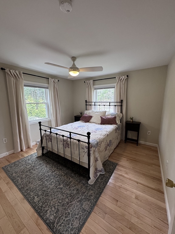 1260 Westhampton Road Northampton, MA 01062 - Photo 17 of 42 a bedroom with a bed and wooden floor