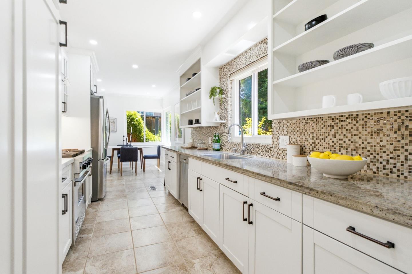 9858 Golf Links Road Oakland, CA 94605 - Photo 5 of 39 a kitchen with stainless steel appliances granite countertop a sink and cabinets
