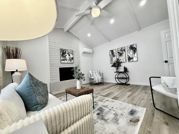 a kitchen with white cabinets a sink and wooden floor